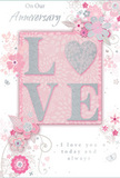 This anniversary card captures the feeling of a private, heartfelt celebration, the kind a couple in Paddington might share after a quiet walk along the canal. The design blends pastel pinks with silvery greys to create a sense of treasured intimacy. At its centre, the word LOVE stands out in softly raised letters, coated with fine glitter so that the surface feels gently textured beneath the fingers. The O is replaced with a shimmering, silver heart, slightly more embossed than the other letters, making it a clear focal point that glows subtly when the card is tilted toward the light. Surrounding the text, delicate blooms in blush and mauve seem to unfurl like watercolour washes, their edges diffused and romantic. Fine, flowing lines connect the flowers in graceful arcs, suggesting trailing foliage, while tiny flourishes-small petals, curling swirls, and near-transparent butterflies-add movement and whimsical touches. The background is a soothing mix of soft pink and pale grey, providing space for the artwork to breathe. Elegant words such as On Our Anniversary and I love you today and always are written in a refined script that echoes the curves of the vines and petals, reinforcing the message of long-lasting love. The overall composition feels carefully composed, like a bespoke bouquet arranged by a local Paddington florist for same-day delivery-perfect for marking an anniversary with something both delicate and deeply meaningful, a keepsake that can be kept long after the flowers have faded.